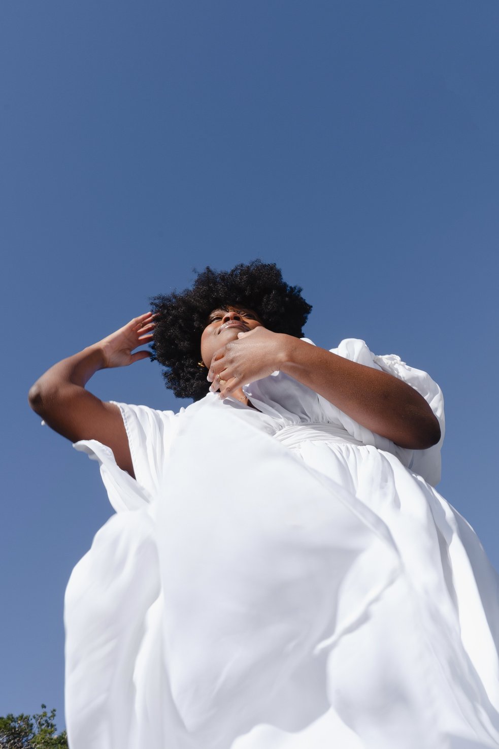 Woman in White Flowy Dress on a Clear Day